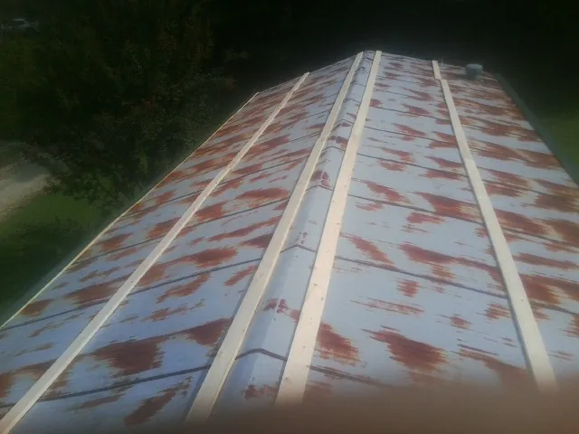 Rusted metal roof panels with new wood purlins before replacement — Storm Damage Roof Repair in Sayreville by Roofing Brothers