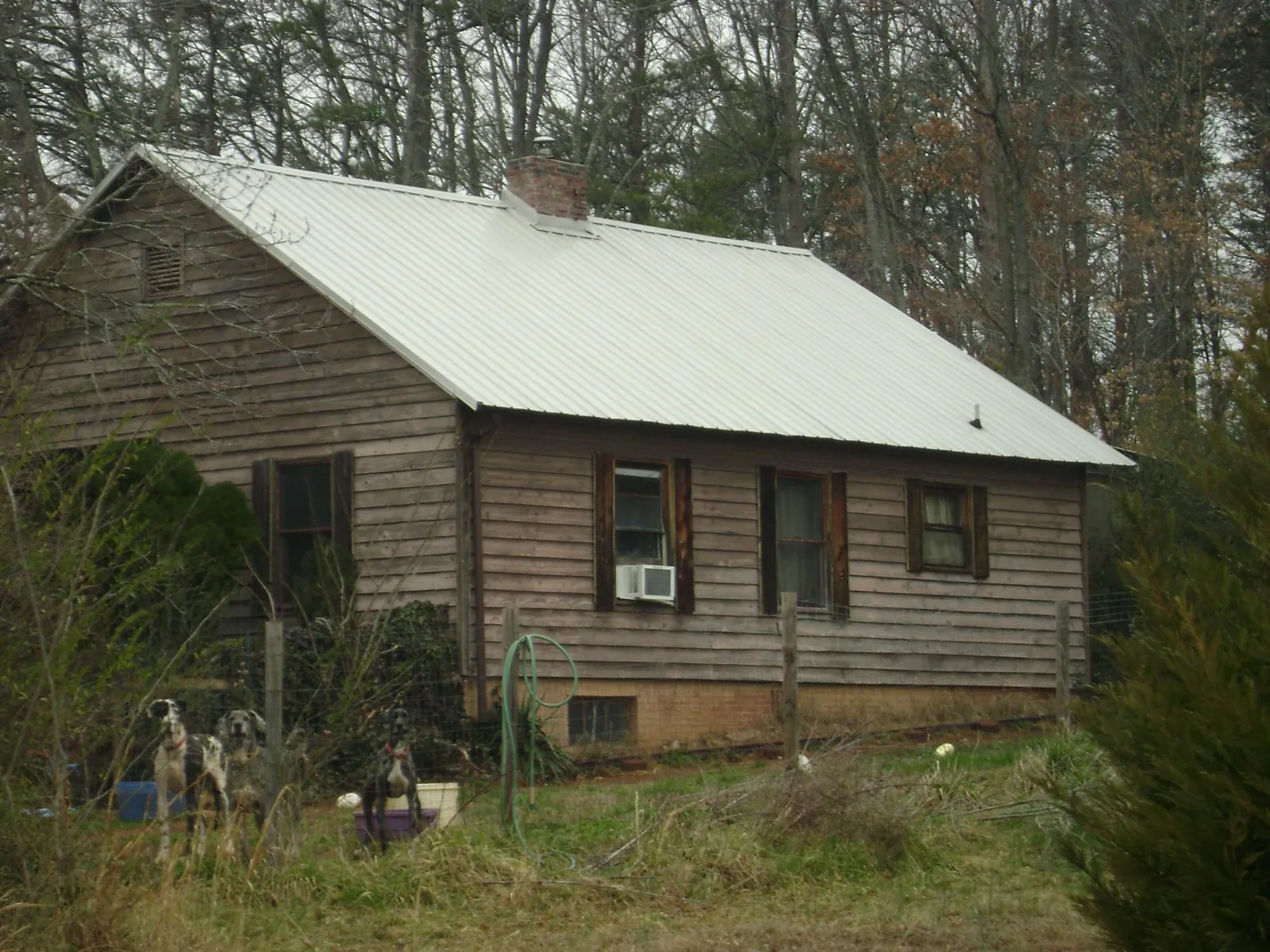 White metal roof on an old wood sided farmhouse, from a Metal Roof Installation job in Sayreville